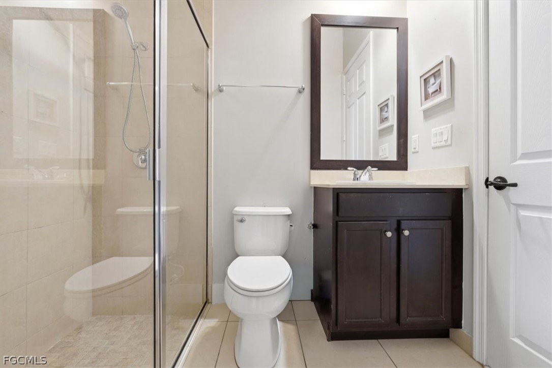 5245 Messina Street Ave Maria, FL 34142 - Photo 7 of 44 a bathroom with a toilet a sink and mirror