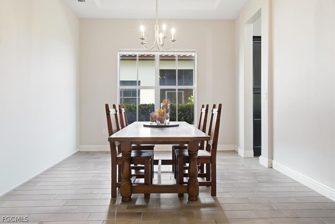 5245 Messina Street Ave Maria, FL 34142 - Photo 8 of 44 a view of a dining room with furniture and chandelier