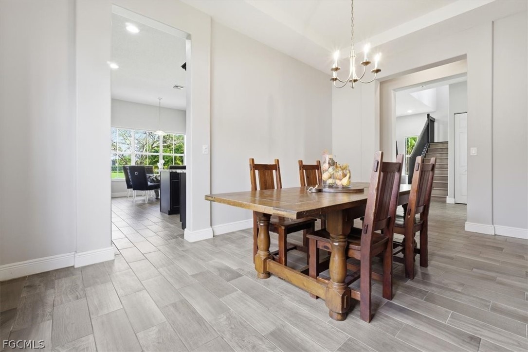 5245 Messina Street Ave Maria, FL 34142 - Photo 9 of 44 a view of a dining room with furniture and wooden floor
