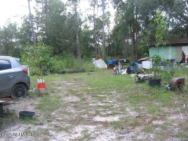 a view of a backyard with a table and chairs