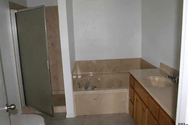 a bathroom with a tub sink and toilet