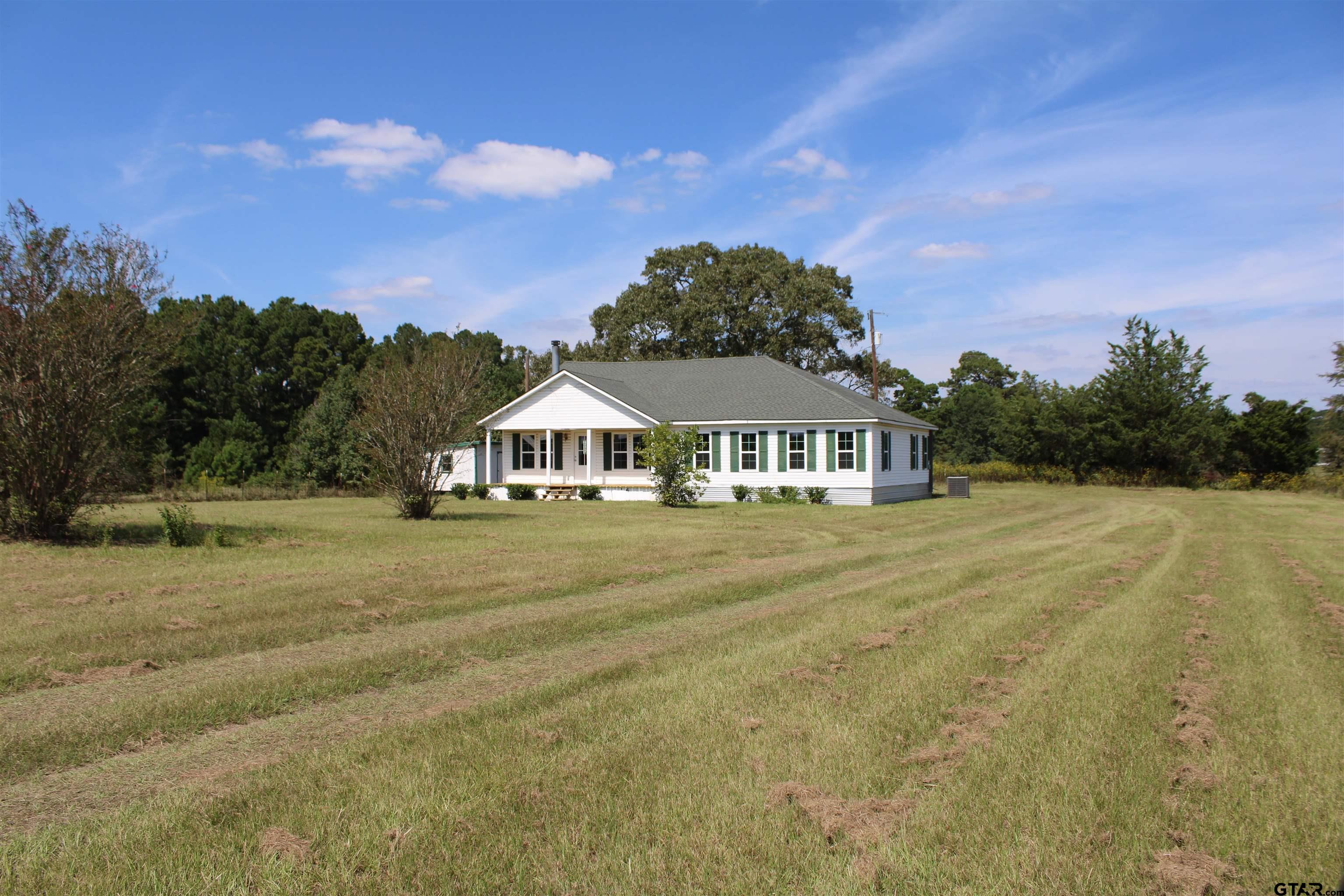 1055 County Road 1314 Rusk, TX 75785 - Photo 19 of 25 a front view of a house with a yard