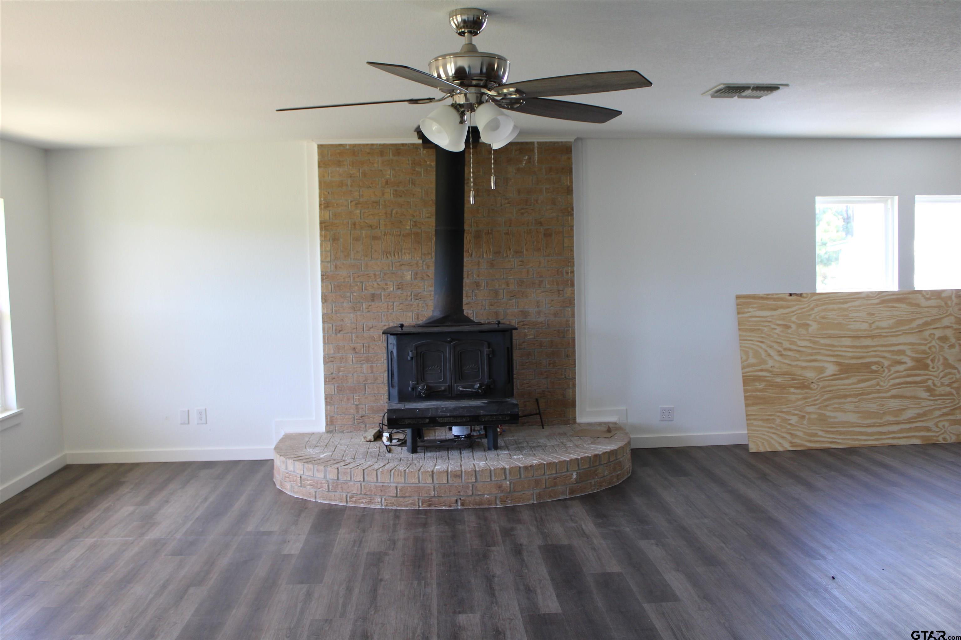 1055 County Road 1314 Rusk, TX 75785 - Photo 5 of 25 a view of a hallway with wooden floor and a fireplace
