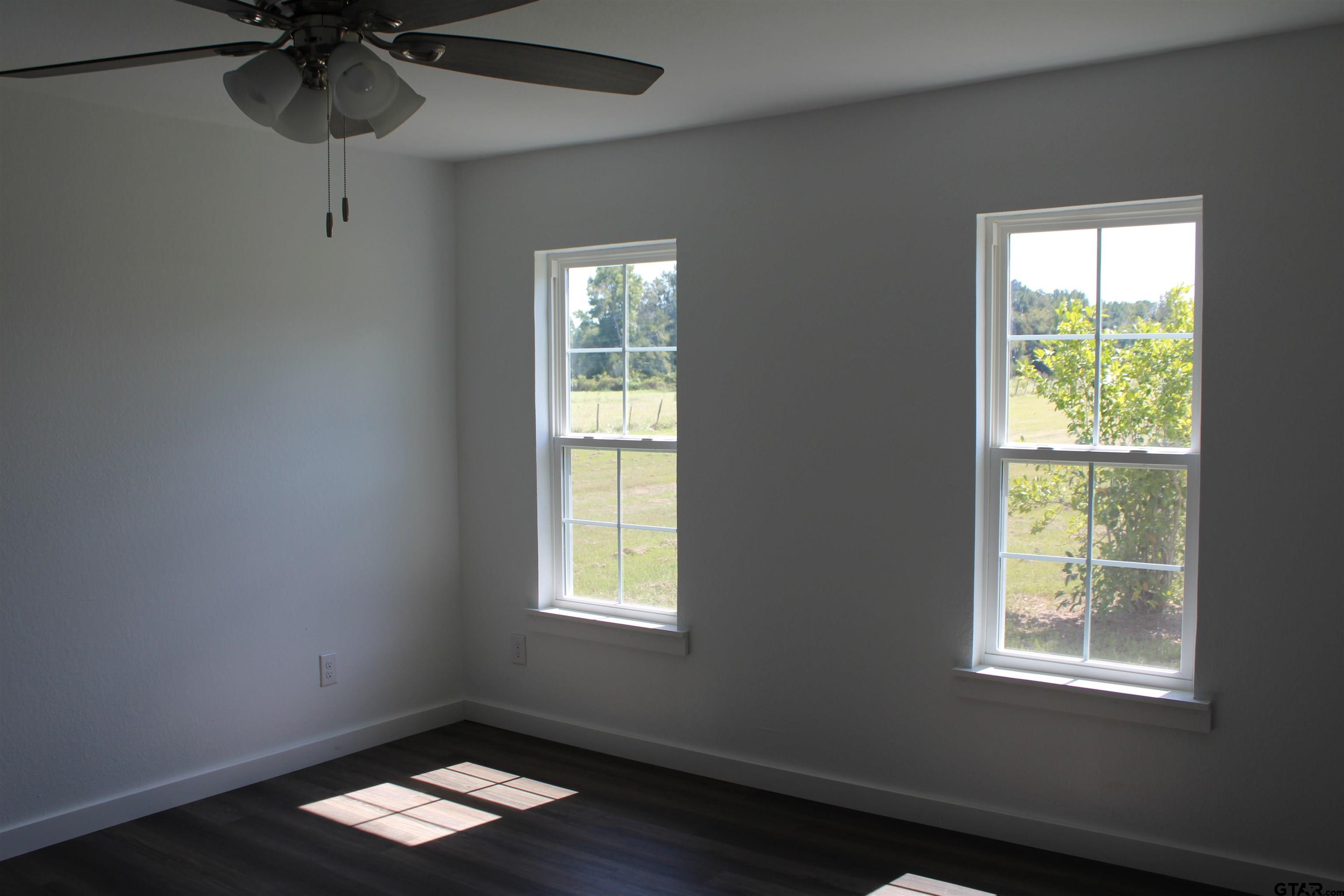 1055 County Road 1314 Rusk, TX 75785 - Photo 6 of 25 a view of room with a window and wooden floor