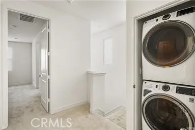 a view of a hallway with washer and dryer