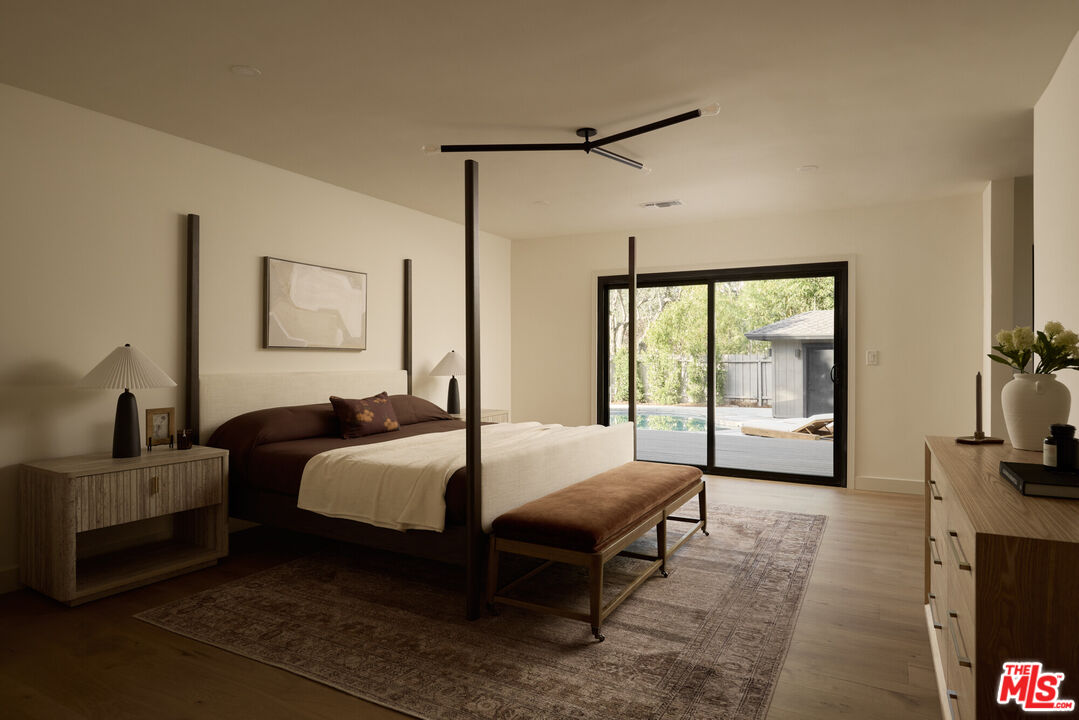 17539 West Magnolia Boulevard Encino, CA 91316 - Photo 16 of 31 a bedroom with a bed window and walk in closet