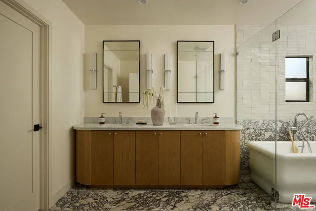 a bathroom with a sink a mirror and a bathtub