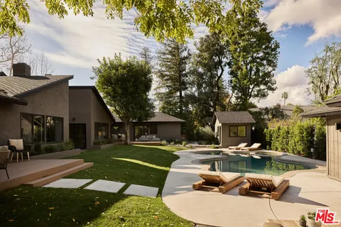 a view of living room with granite countertop furniture and chandelier