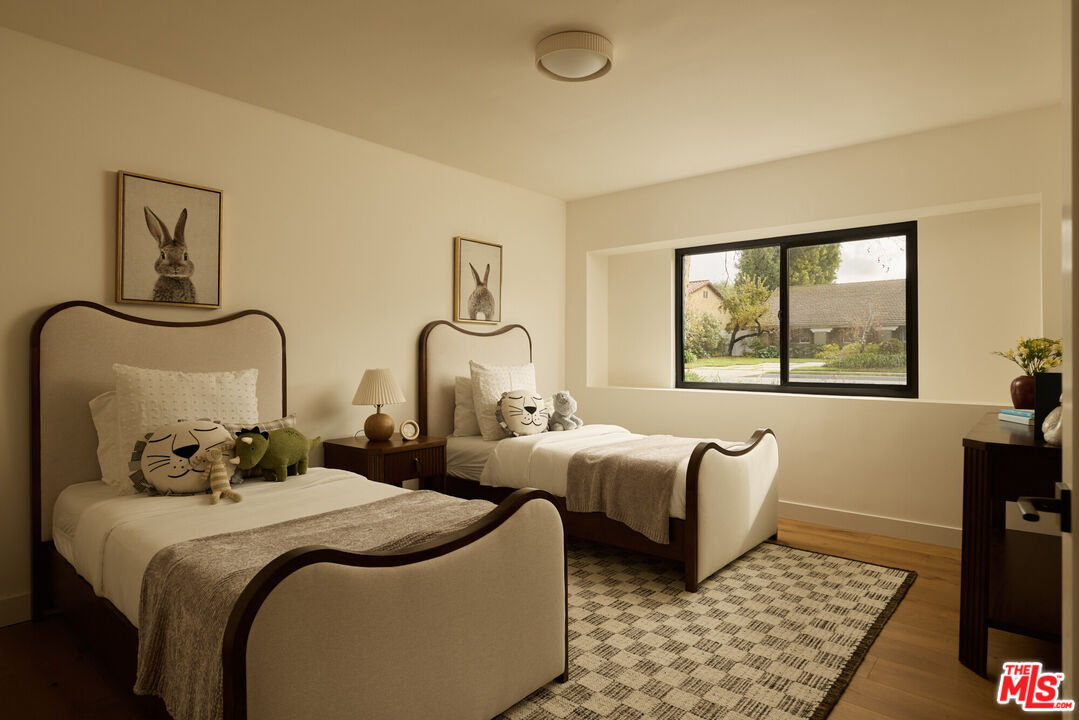 17539 West Magnolia Boulevard Encino, CA 91316 - Photo 21 of 31 a bedroom with two beds and a window