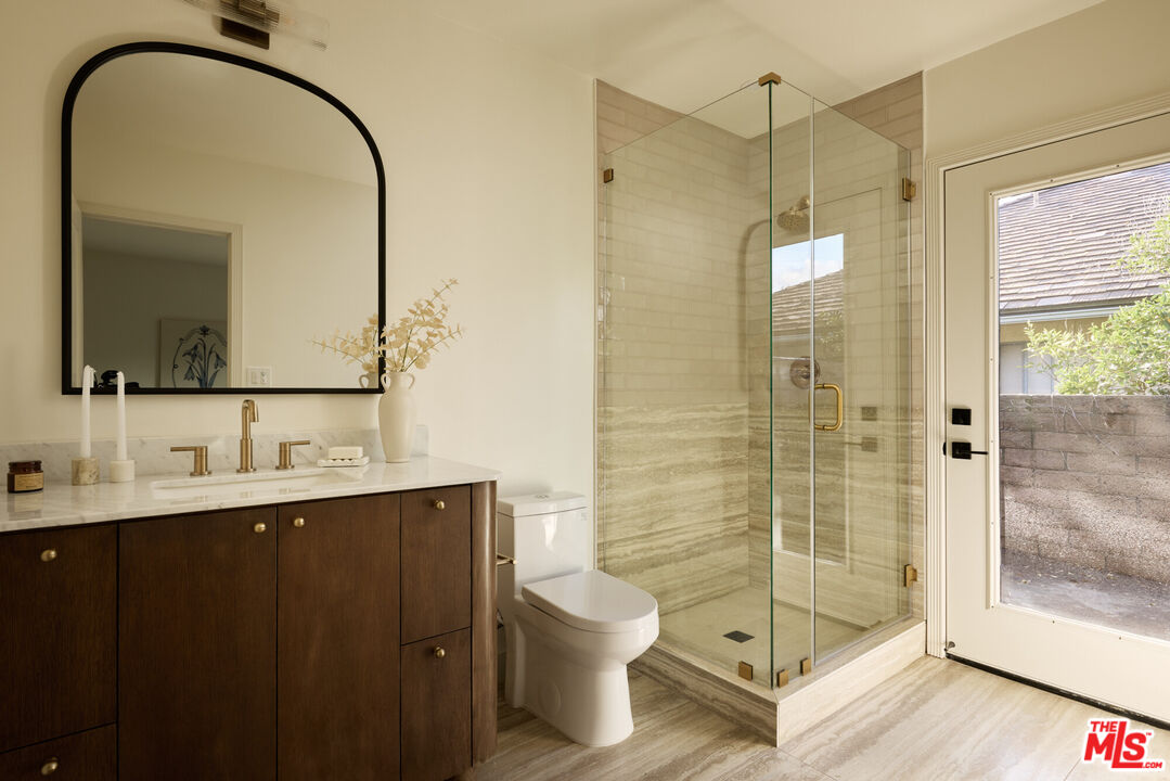 17539 West Magnolia Boulevard Encino, CA 91316 - Photo 24 of 31 a bathroom with a sink a toilet and shower