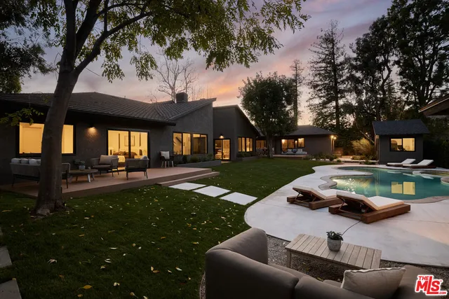 a view of a backyard with sitting area