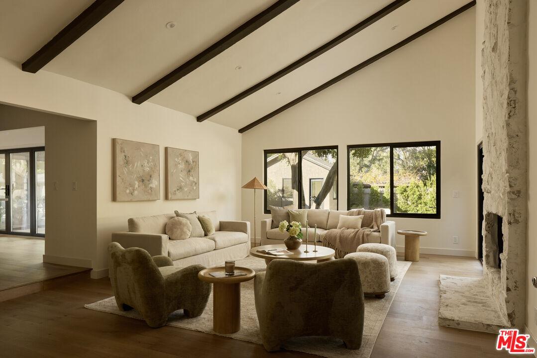 17539 West Magnolia Boulevard Encino, CA 91316 - Photo 9 of 31 a living room with furniture and a large window