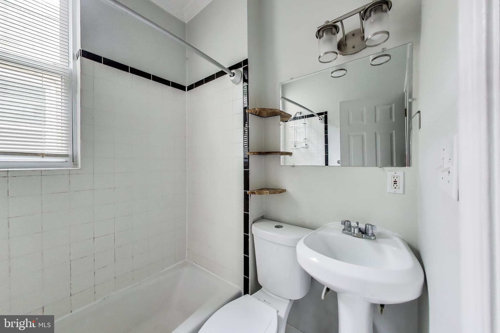1327 1st Street Northwest Washington, DC 20001 - Photo 15 of 18 a bathroom with a sink a toilet and shower