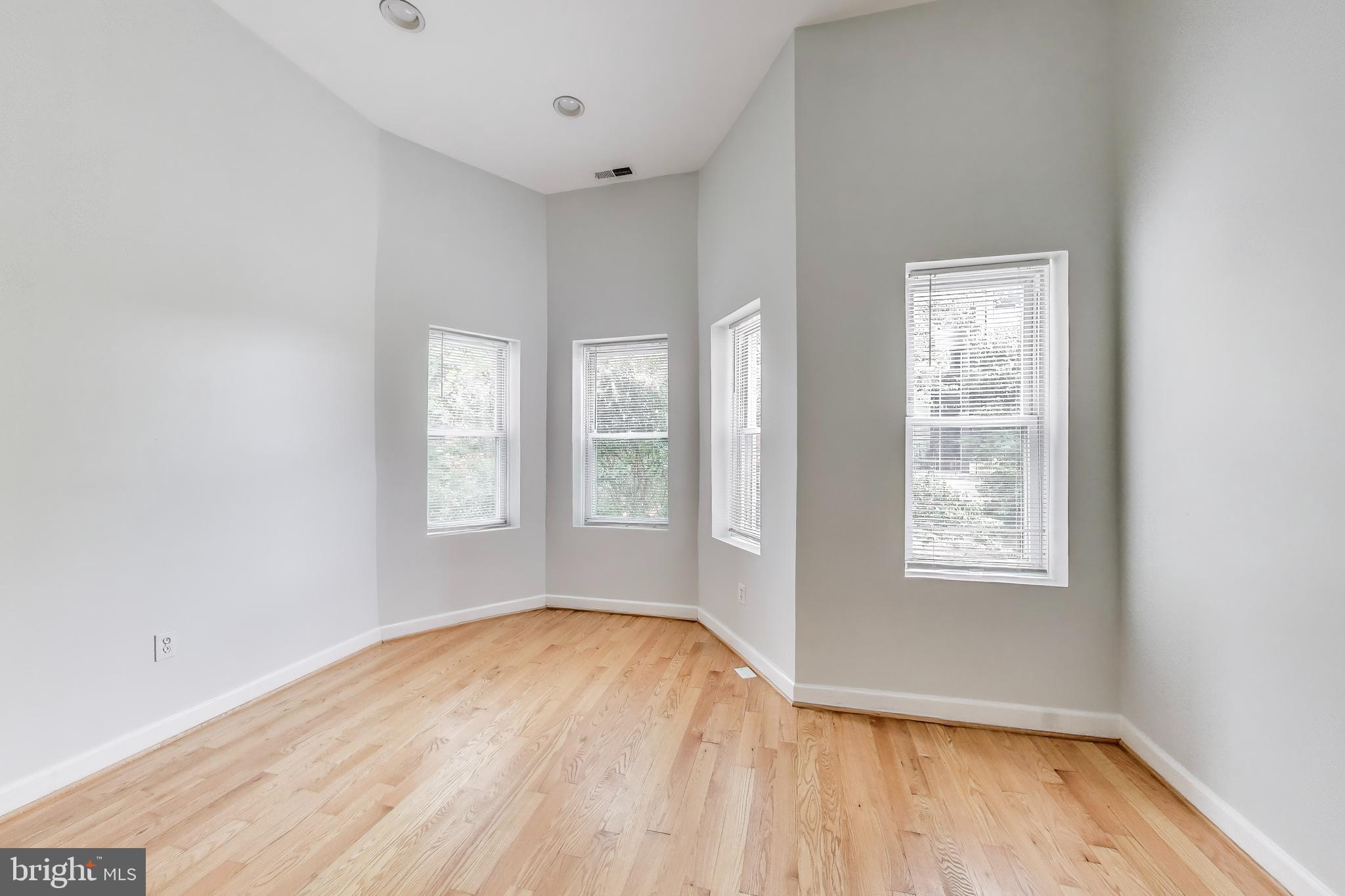 1327 1st Street Northwest Washington, DC 20001 - Photo 8 of 18 an empty room with wooden floor and windows