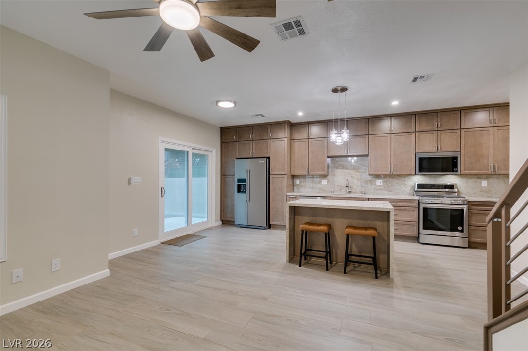 540 Sutters Mill Road Henderson, NV 89014 - Photo 14 of 46 This open concept kitchen and living area offers stylish features and a seamless flow for daily living.