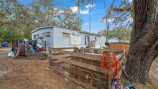 a view of a house with a small yard and furniture