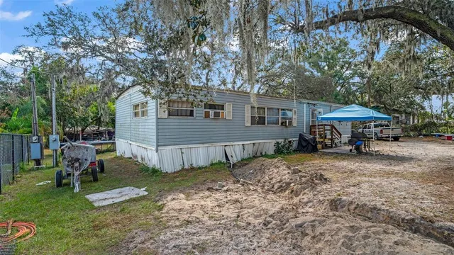 a view of a house with backyard and sitting area