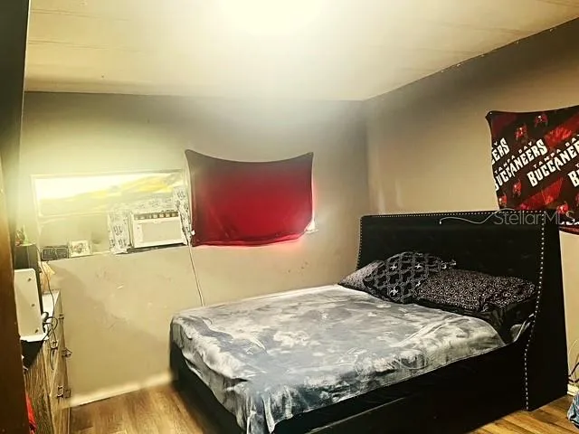 a bedroom with a bed and a wall painting