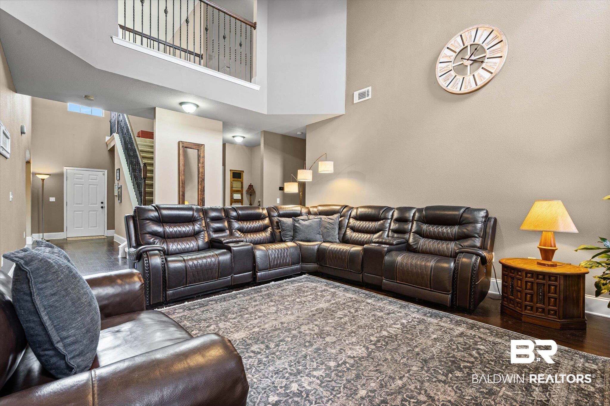 585 Sheffield Avenue Foley, AL 36535 - Photo 5 of 45 Open-concept living area featuring high ceilings and dark wood-finish flooring
