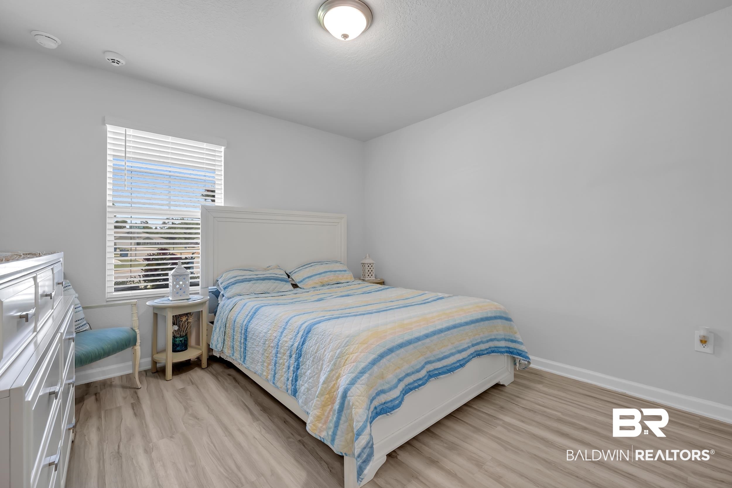 24271 Ringneck Loop Elberta, AL 36530 - Photo 26 of 44 Room featuring light wood-finish flooring, white baseboards, and neutral wall paint