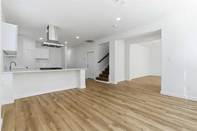 a view of kitchen with kitchen island white cabinets and refrigerator