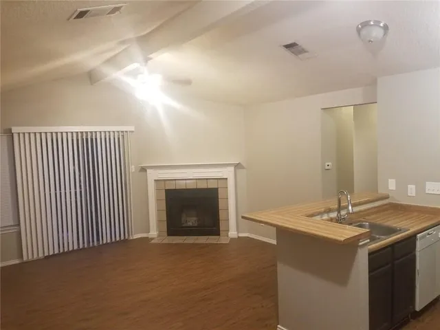 a hall with a sink and a fireplace