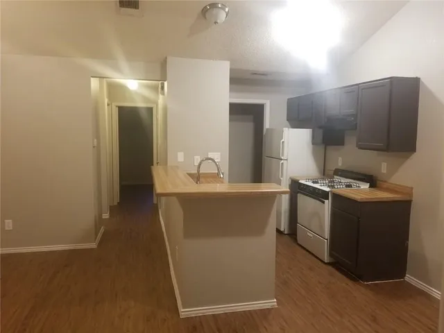 a kitchen with stainless steel appliances a refrigerator and a stove