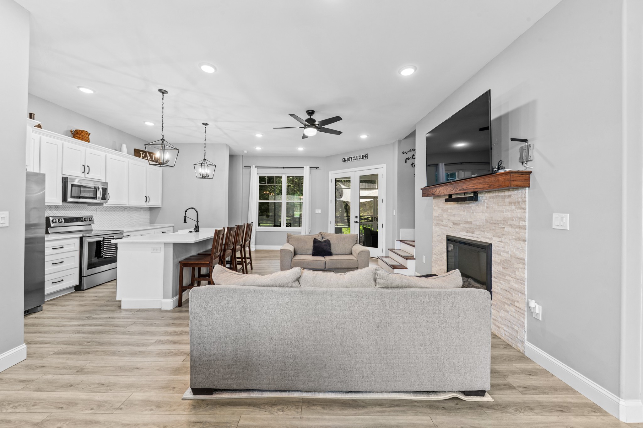 4770 Delina Road Cornersville, TN 37047 - Photo 32 of 71 a living room with furniture a fireplace and a kitchen view