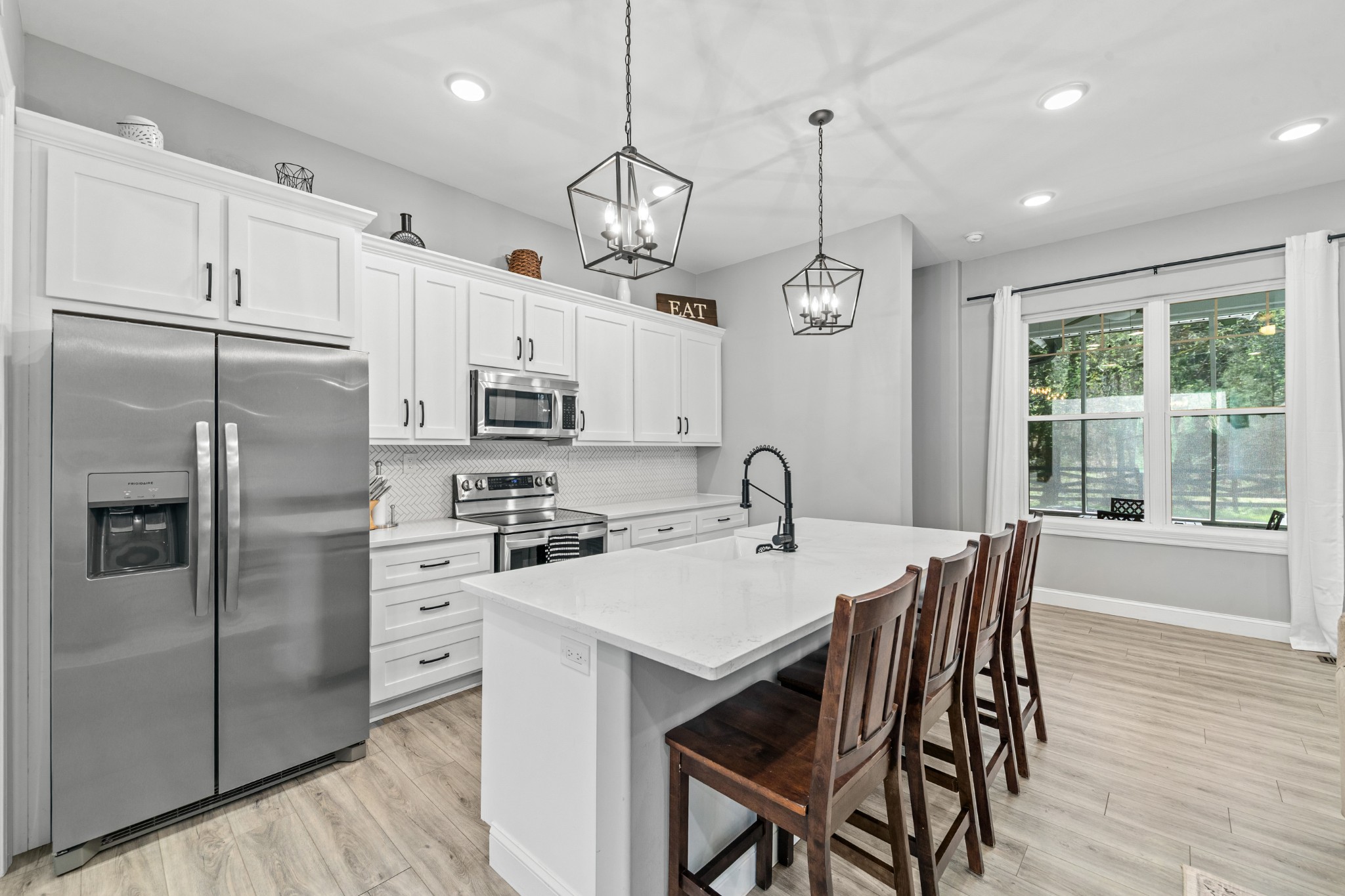 4770 Delina Road Cornersville, TN 37047 - Photo 40 of 71 a kitchen with stainless steel appliances granite countertop a dining table chairs refrigerator and microwave