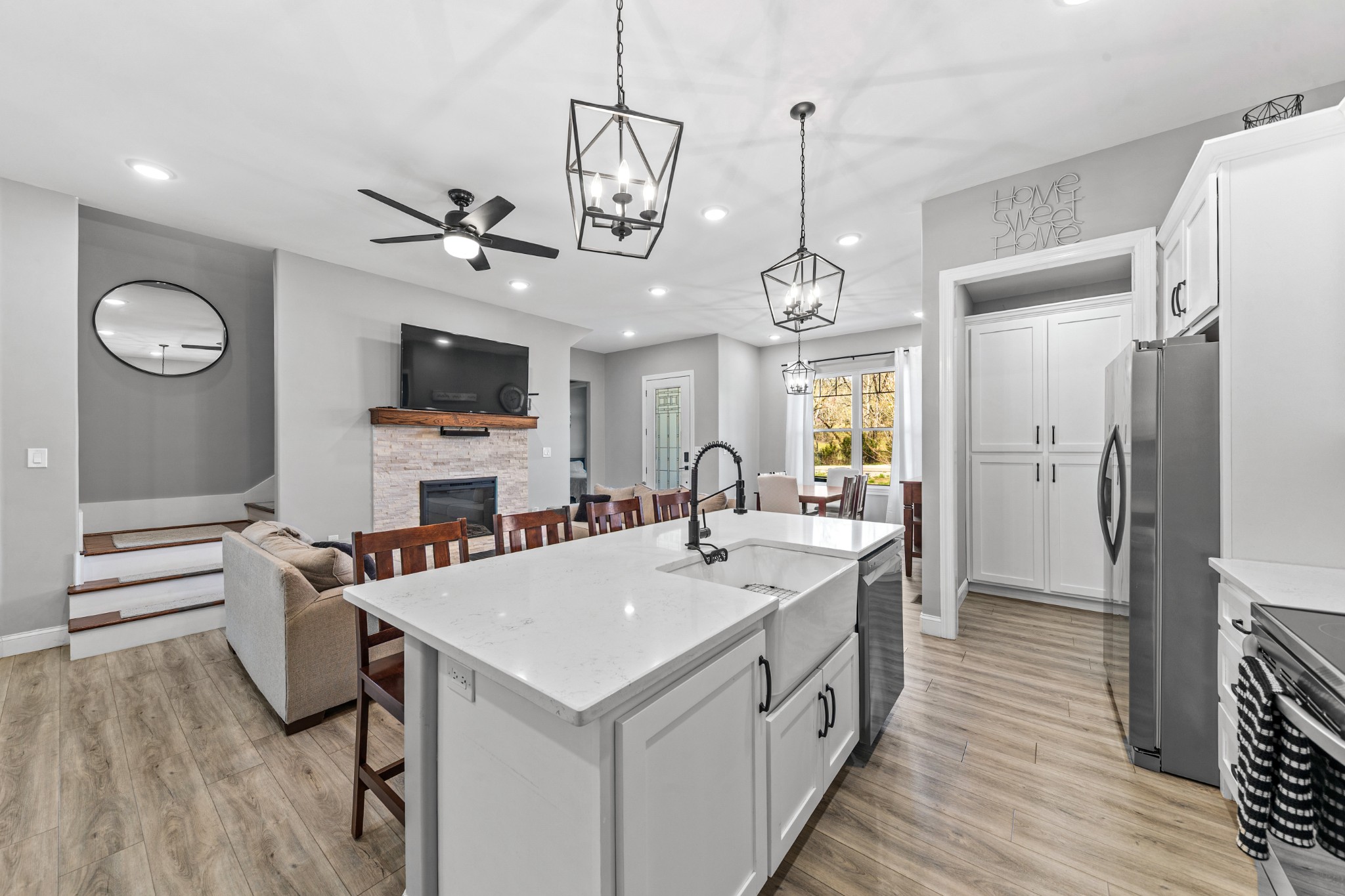 4770 Delina Road Cornersville, TN 37047 - Photo 42 of 71 a large white kitchen with a refrigerator a stove a sink dishwasher a dining table and chairs with wooden floor