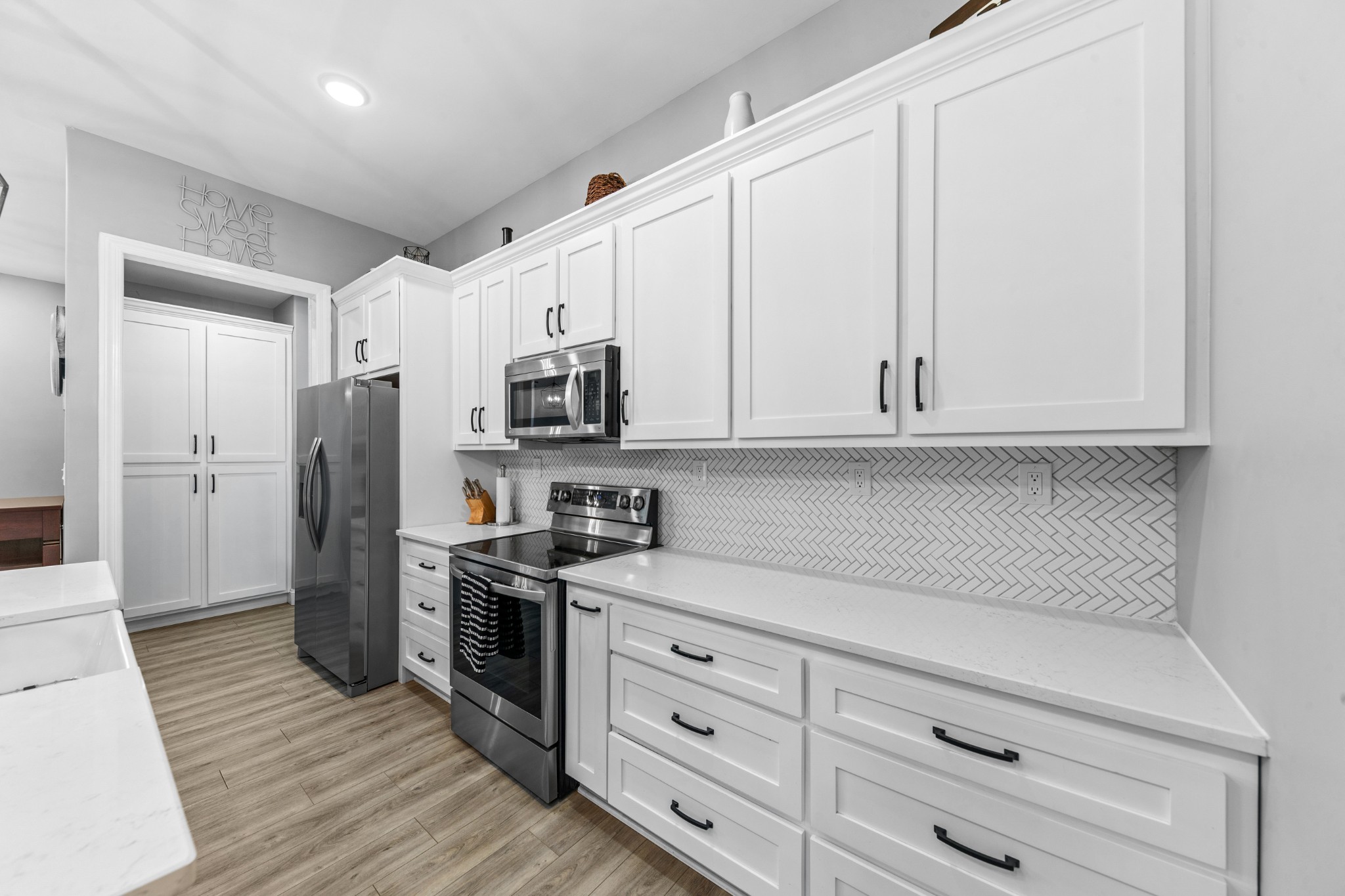 4770 Delina Road Cornersville, TN 37047 - Photo 43 of 71 a kitchen with white cabinets and stainless steel appliances