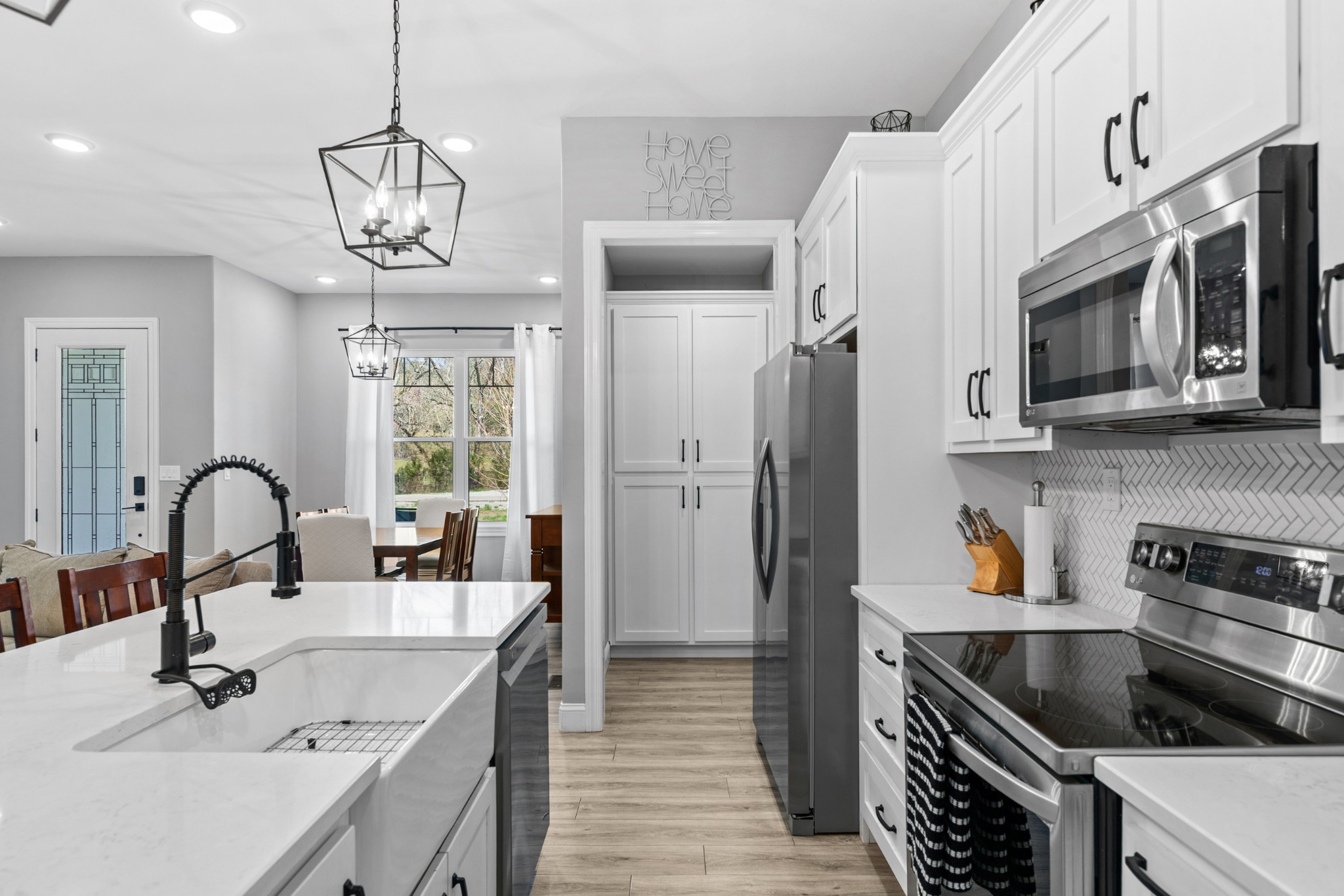 4770 Delina Road Cornersville, TN 37047 - Photo 45 of 71 a kitchen with stainless steel appliances sink a microwave and cabinets