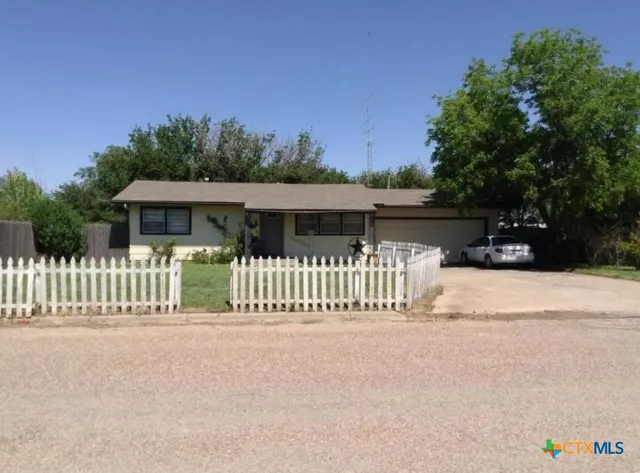 a view of a house with wooden fence