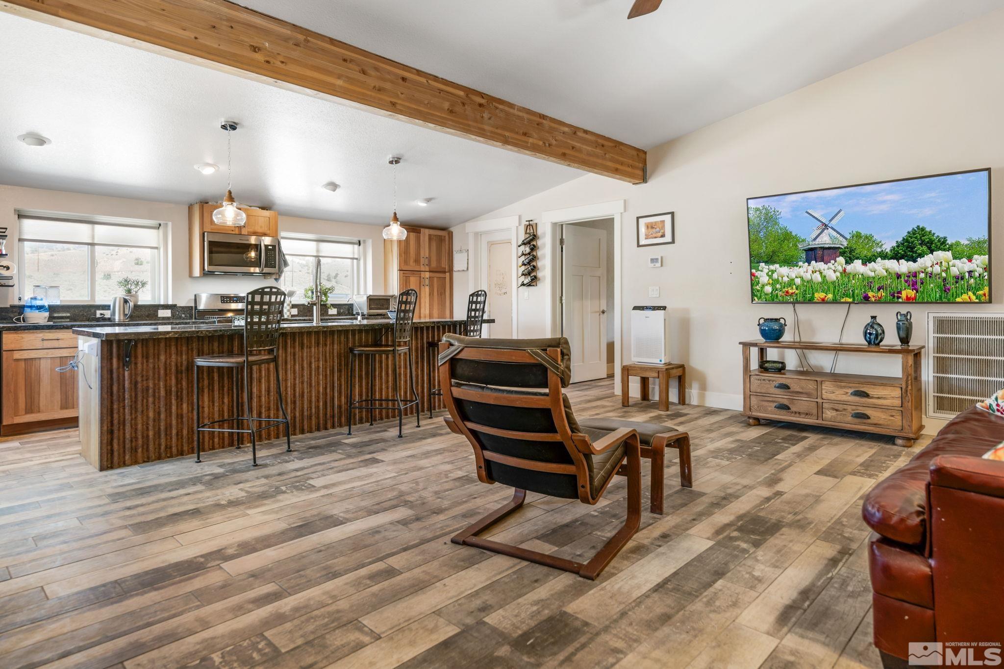 205 Eagle Vw Trail Dayton, NV 89403 - Photo 11 of 40 a living room with furniture a kitchen view and a fireplace