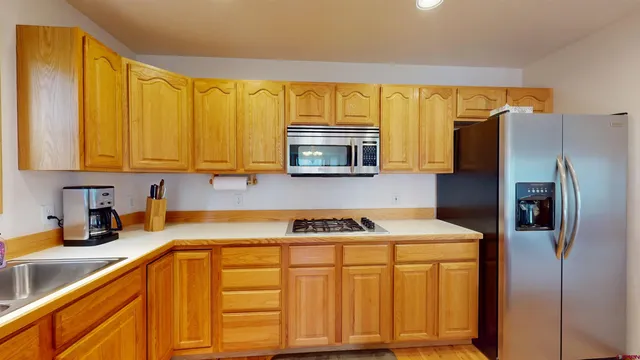 a kitchen with a sink a refrigerator and a cabinets
