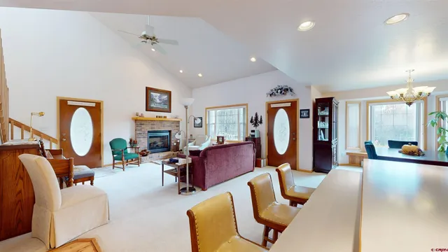 a living room with furniture a fireplace and a chandelier