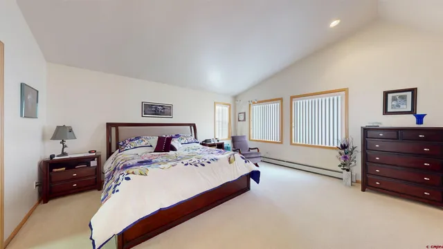 a bedroom with a bed and a dresser