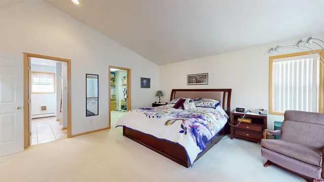 a bedroom with a bed couch and a window