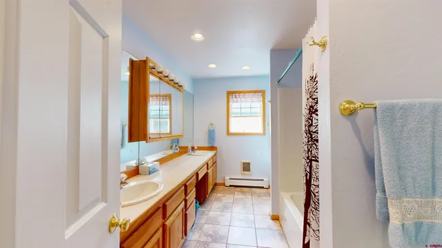 a bathroom with a tub and shower