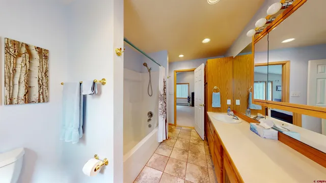 a room with furniture a rug and a mirror