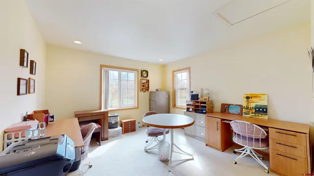 a living room with furniture a window and a dining table