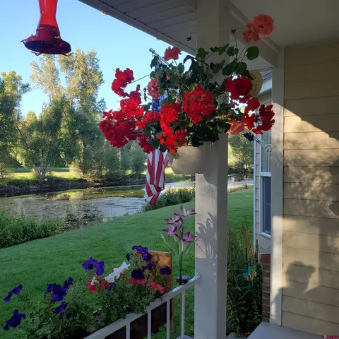 a view of a house with a yard and a wooden fence