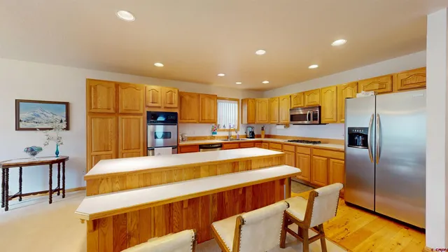 a kitchen with a refrigerator and a sink