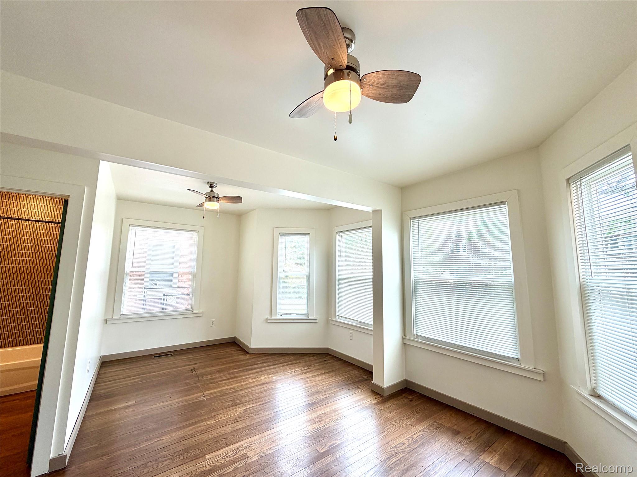 2045 Calvert Avenue Detroit, MI 48206 - Photo 30 of 41 Unfurnished room featuring dark wood finished floors and a ceiling fan