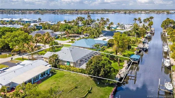 an aerial view of a house with a lake view