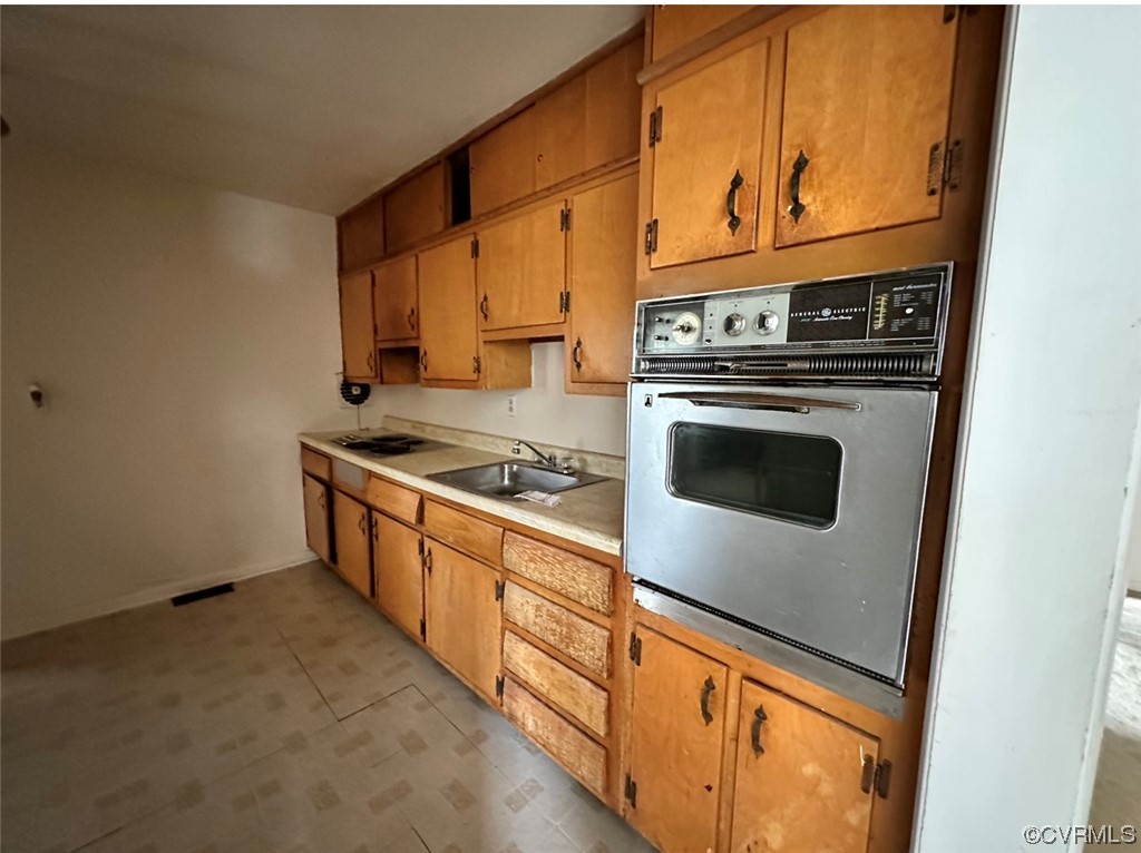 3907 Rosedale Avenue Richmond, VA 23227 - Photo 10 of 10 a kitchen with stainless steel appliances granite countertop a stove and a refrigerator