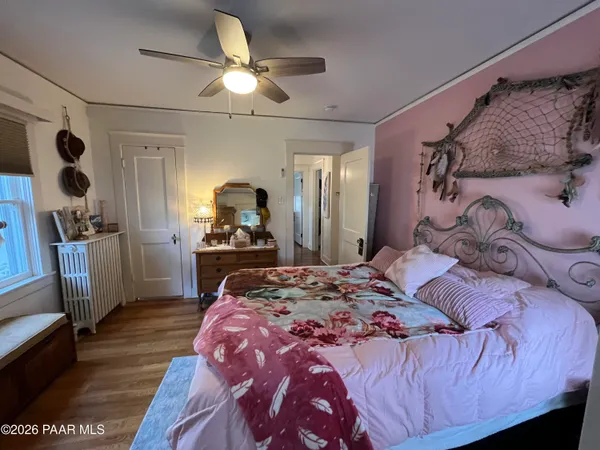 a kitchen with stainless steel appliances kitchen island granite countertop a table chairs and a wooden floor