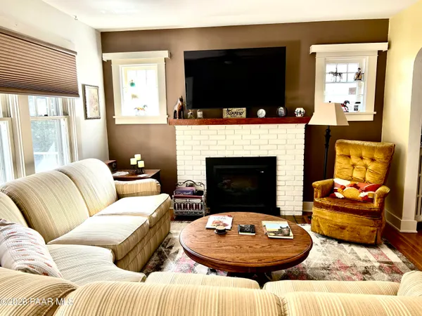 a living room with furniture fireplace and a flat screen tv