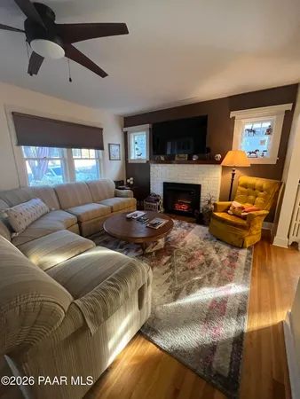 a view of a living room with a table and chairs