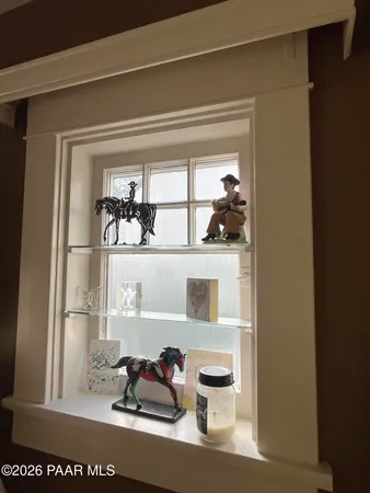 a bedroom with a bed and a mirror on the dresser